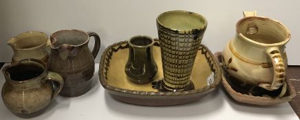 A collection of glazed art ware pottery including two Sidney Tustin Winhcombe Pottery jugs,