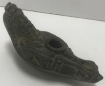 A Syrian carved stone oil lamp in the an