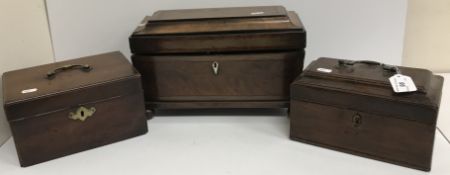 An early 19th Century figured mahogany tea caddy of sarcophagus form opening to reveal a fitted