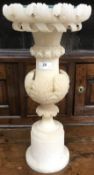 A 19th Century carved alabaster jardiniere stand with acanthus and ribbon decoration,