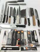 A large collection of assorted kitchen knives, some boxed and apparently unused,