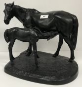 A mid 20th Century Russian cast iron and patinated figure group of a mare and foal dated to the