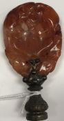 A Chinese carved agate medallion, now as