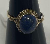 An 18-carat gold oval cabochon lapis laz