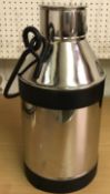 A stainless steel milk churn with swing