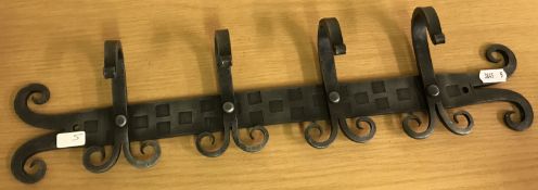 A hand forged set of four hooks mounted