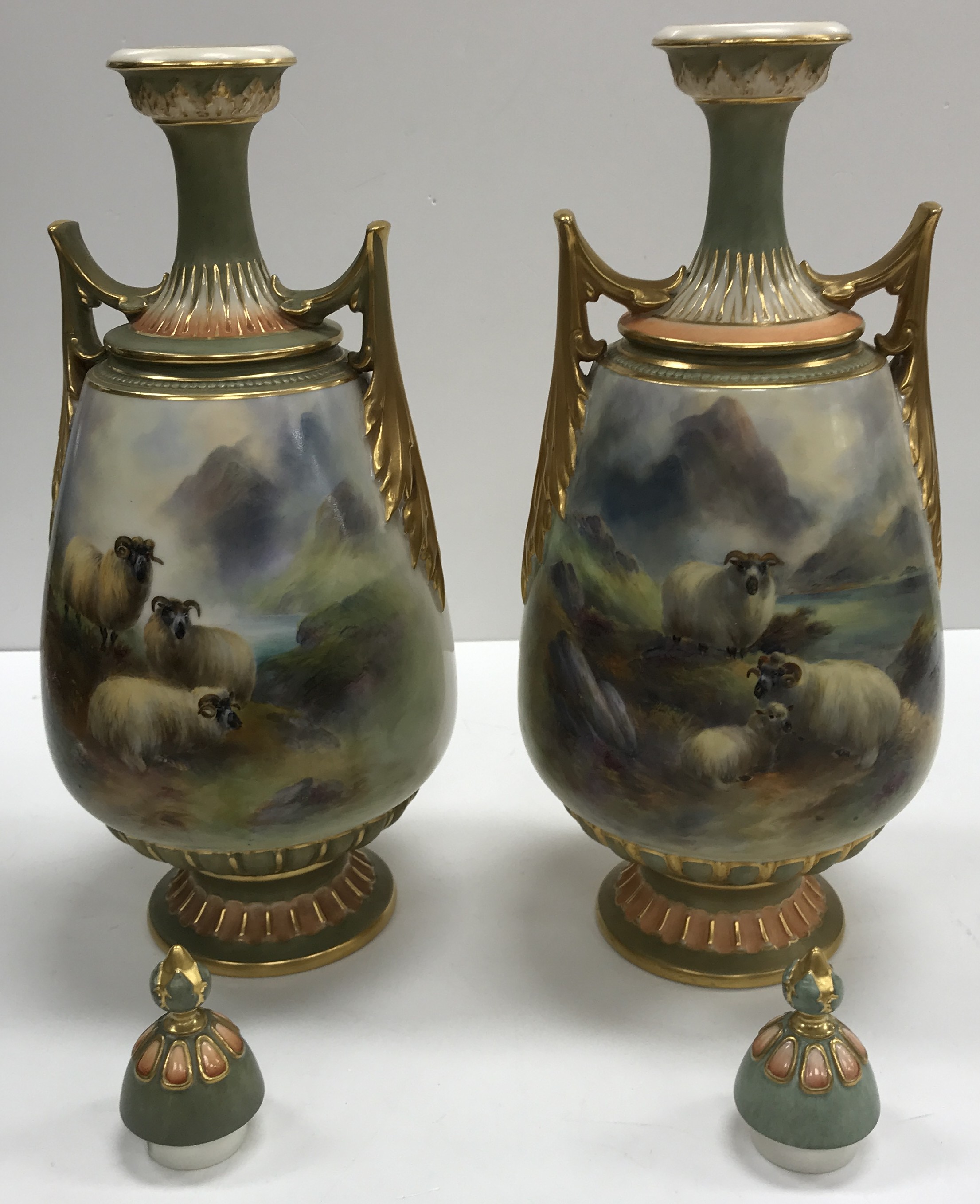 A pair of Royal Worcester porcelain vases and covers with hand painted