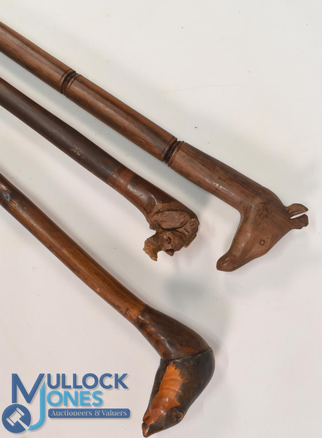 Selection of Walking Sticks all having carved animal heads to include Badger, Giraffe, Rhinoceros (