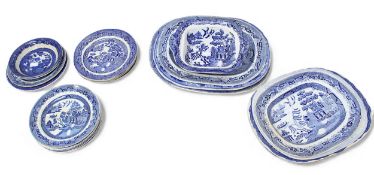 A quantity of mostly 19th century blue and white transfer printed pottery serving dishes and plates,