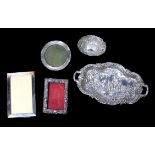 A late 19th century small twin-handled silver tray of shaped form, embossed with a Watteau style