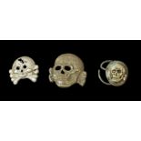 A German SS Totenkopf death skull badge die stamped metal, unmarked, two fold-over flattened