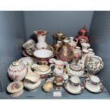 A quantity of various vases, urns, cups & saucers, milk jugs, bud vases etc of the pale pink/