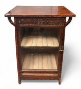 A late 19th Century Aesthetic movement mahogany display cabinet, the cleated ends raised on curved