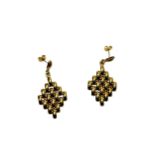 A pair of '750' gold pendant earrings, each hung with articulated brick links in a lozenge shape,