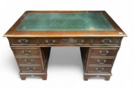 A 20th century mahogany pedestal desk, with inset gilt-tooled, green leather scribe, above three