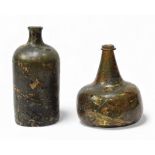 An early 18th century onion-shaped wine bottle, of typical form, the olive-green glass with an