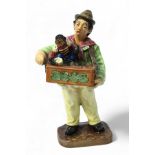 A Royal Doulton figure ‘Organ Grinder HN2173’, copyright 1955, with factory marks to base.