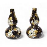 A pair of late 19th Century Wedgwood double-gourd bud vases, c.1878, painted with prunus and gilt
