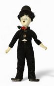 A Charlie Chaplin porcelain doll, possibly relating to the stage production ‘Chaplin’, modelled as