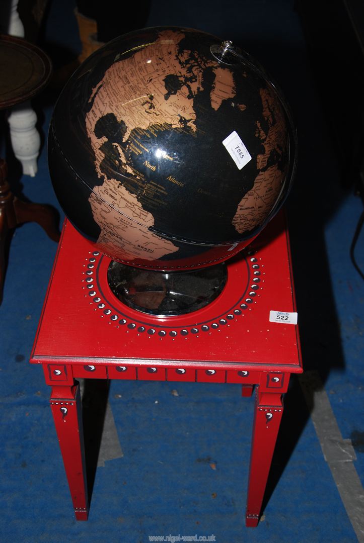 A small painted table and a globe.