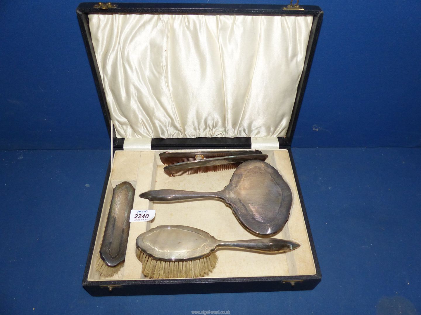 A Silver backed brush, comb and mirror seat in original case, Birmingham 1929 makers B & Co,