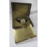A Longines wrist watch, with gold coloured case and leather strap, boxed