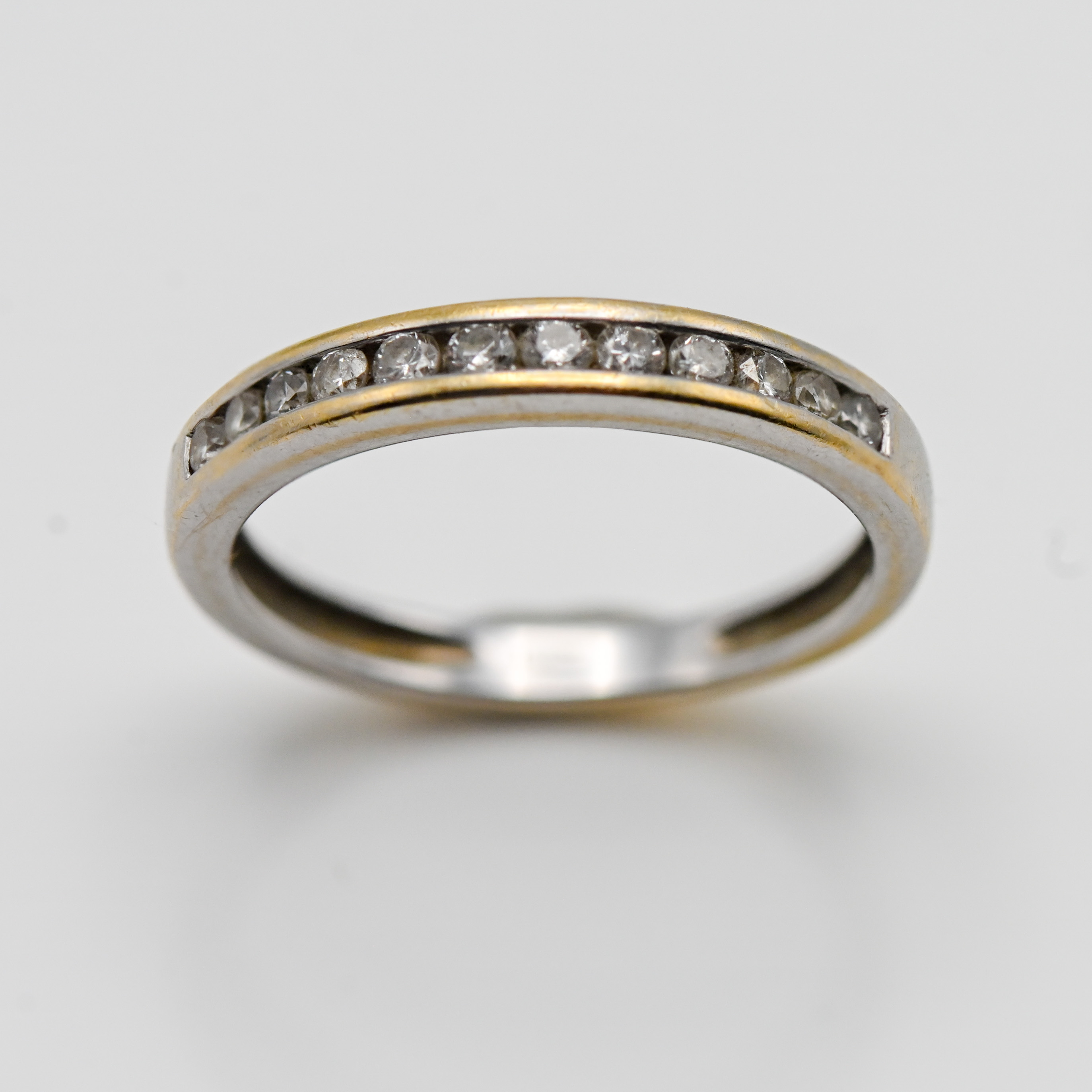 A diamond half eternity ring (not hallmarked), size K.