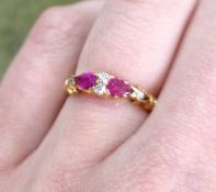An antique ruby and diamond dress ring, set with a pair of pear cut rubies