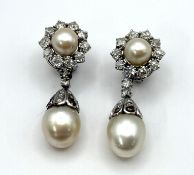 A fine pair of large pearl and diamond drop earrings