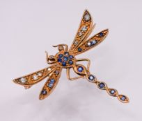 A gold Dragonfly brooch, decorated throughout with diamonds and sapphires