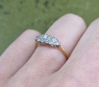 An 18ct diamond ring set with an arrangement of ten diamonds in a two row setting