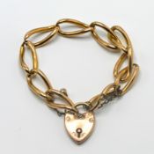 A 9ct gold link charm bracelet set with heart padlock, approx 22.9g.