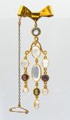 A stylish bow bar brooch set with moonstones and garnets, set in 9ct yellow gold, total weight 11.