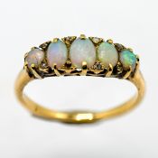 A five stone opal ring set with small diamonds, set in yellow gold (not hallmarked), size Q,