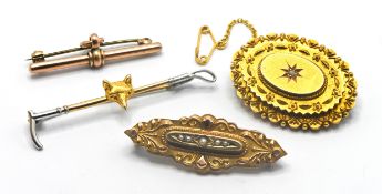 A 15ct gold brooch with lock of hair to reverse approx 8.8g together with three 9ct gold brooches