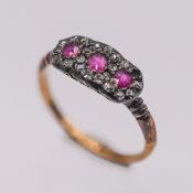 An Edwardian ruby and diamond triple cluster ring, set in 18ct yellow gold, size L/M, approx 2.1g.