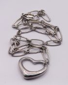 Tiffany & Co, a silver open heart Elsa Peretti necklace on a link chain.