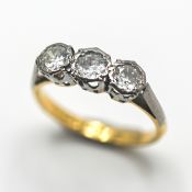 A three stone diamond ring, set in 18ct yellow gold, size K.