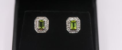 A pair of peridot and diamond set earrings, set in 14ct white gold, approx 3.4g.
