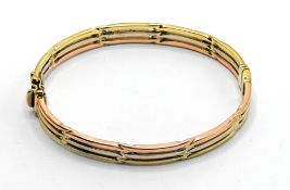 A 9ct gold three tone colour bangle, approx 15.7g.