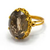 A large smokey quartz dress ring, set in 18ct yellow gold, size Q, total weight 9g.