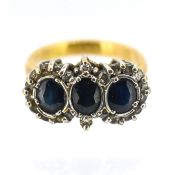 A three stone sapphire and diamond cluster ring, set in yellow gold (not hallmarked), size K, approx
