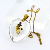 A large Victorian rock crystal pendant on trace link chain, of heart shape design, set with diamonds