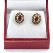 Pair of oval ruby and diamond halo studs, set in gold plated silver, rubies 0.45ct approx,