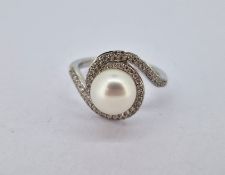 A diamond and pearl swirl ring, set in 18ct white gold, size N, approx 5.4g.