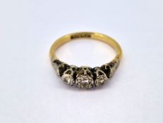 A three stone diamond dress ring, set in 18ct yellow gold, size L/M, approx 2.6g.
