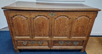 An oak early 19th century Lancashire chest, of panelled design with elaborate brass lock and