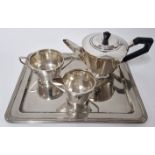 An art deco style silver tea service, to include teapot with ebonised wood handle, milk jug, and