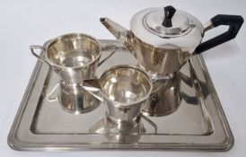 An art deco style silver tea service, to include teapot with ebonised wood handle, milk jug, and