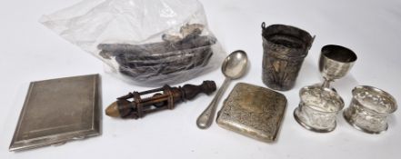 A collection of silver items, to include cigarette cases, small trophy, spoon, brush silver backs